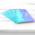 Pearlized business cards laying on a marble table.